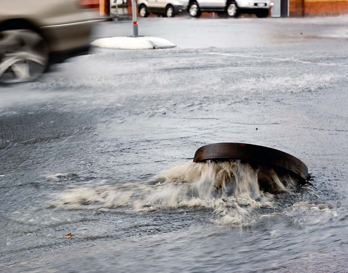 Water coming out of sewer on a street - Stormwater Management